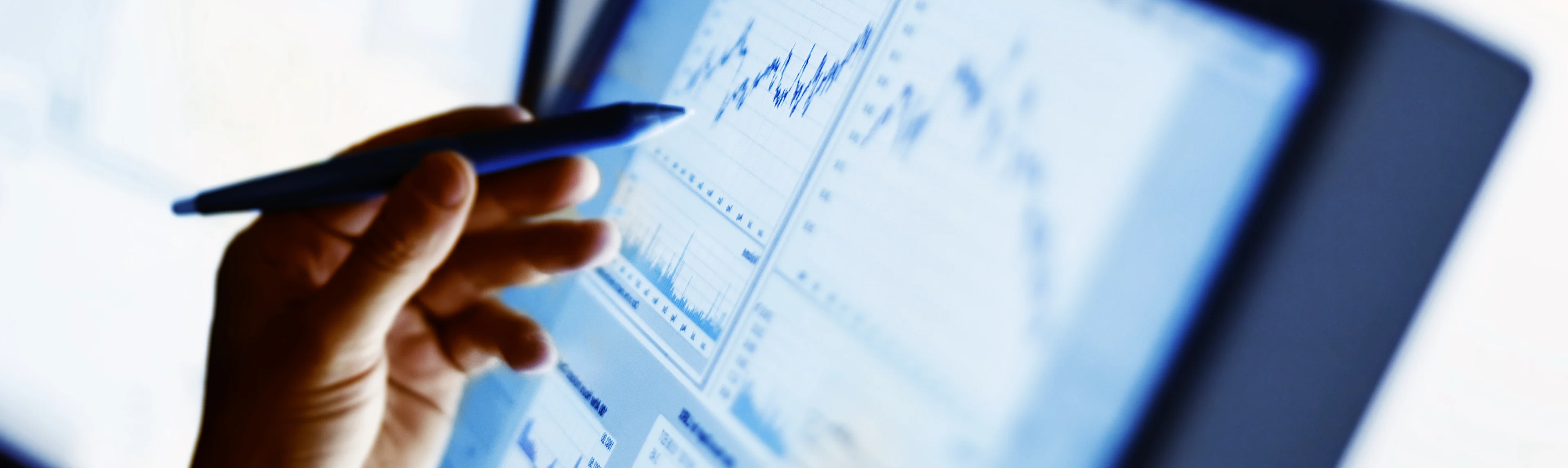 A person looking at pricing data graphs