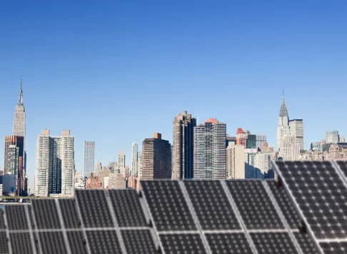 Solar panels in the foreground with the New York City skyline