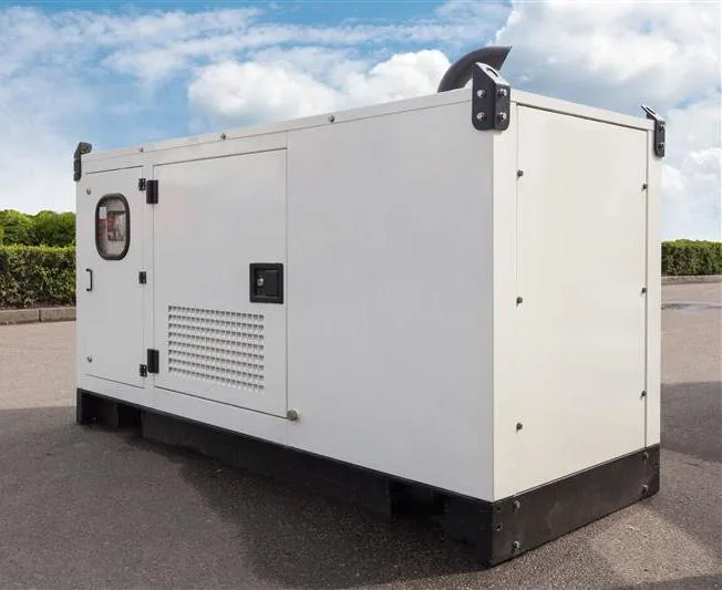 A large white industrial generator set placed outdoors on a paved surface