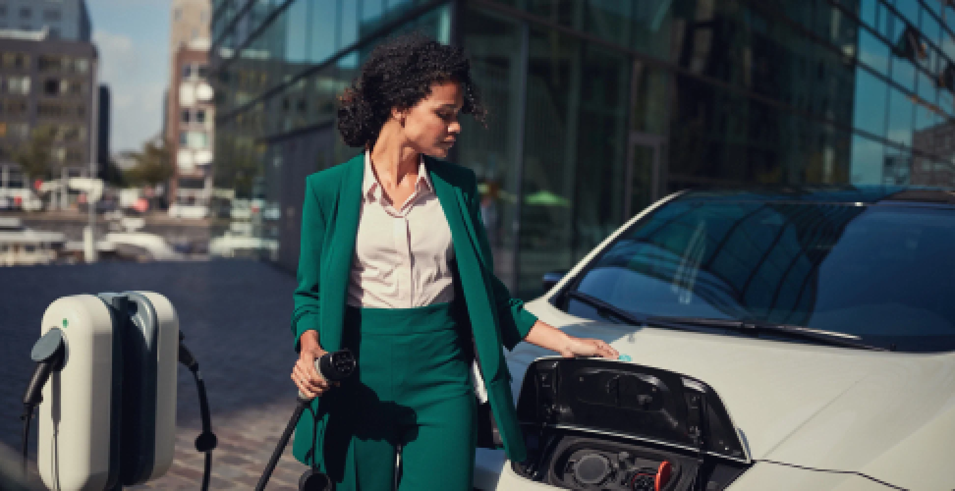 Woman charging a white ev