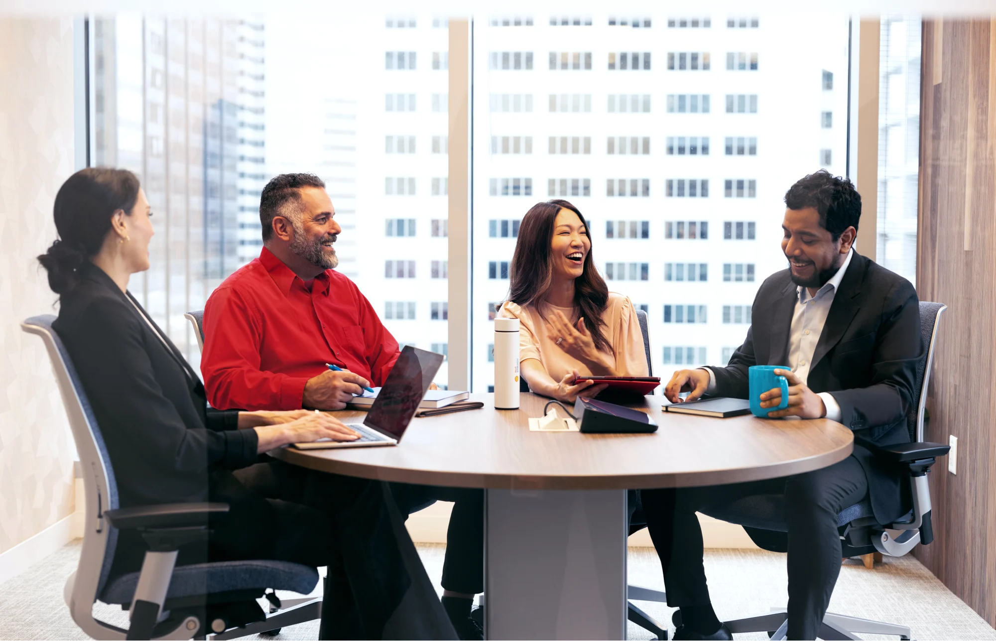 A group of people sitting in a meeting room in discussion.